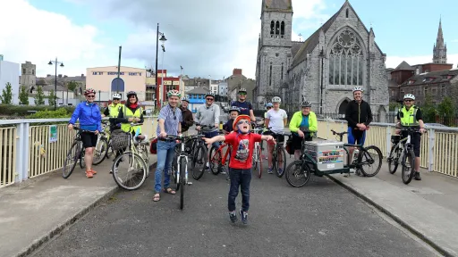 A group of Drogheda cyclists on St. Dominic's Bridge with Abbey Centre and Dominican Church in background