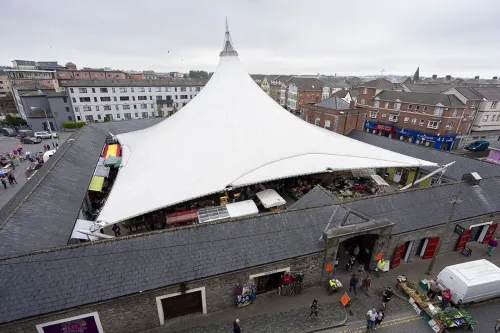 Exterior of Limerick Milk Market with large canvas roof surrounded by permanent buildings